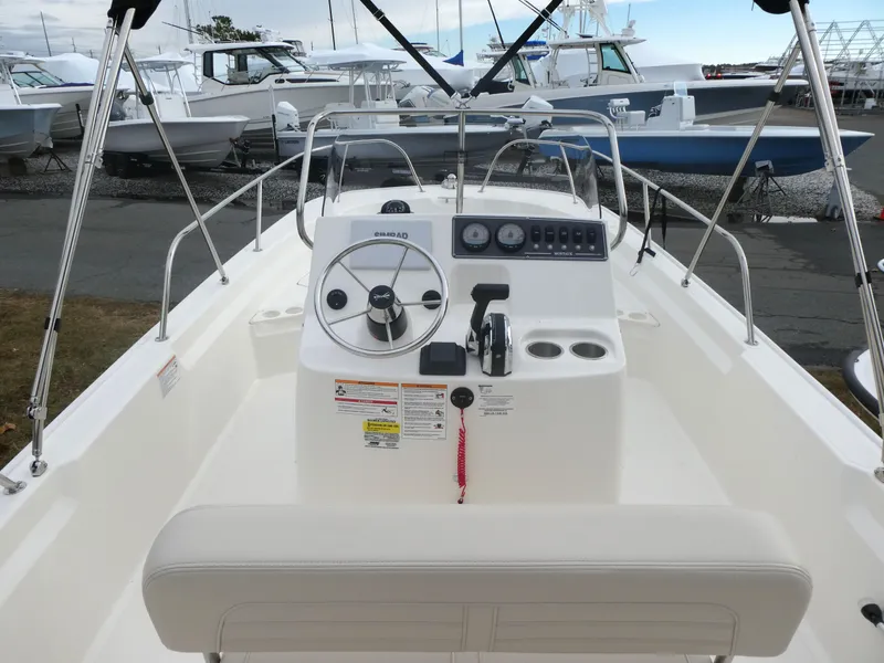 Slide: The Image of 2024 Boston Whaler 190 Montauk boat interior with steering console and seating. - 6