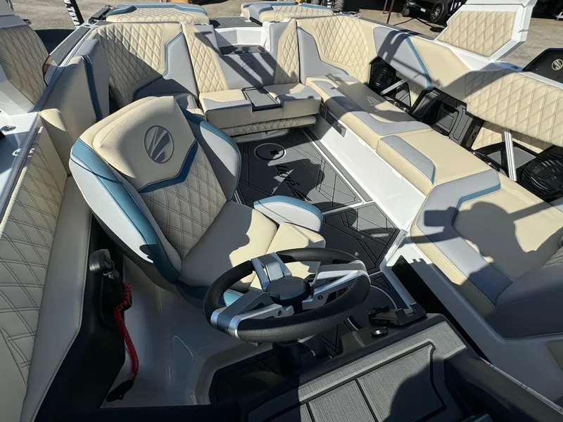 Slide: The Image of 2025 Tigé 22RZX boat interior with luxurious seating and modern steering wheel. - 10