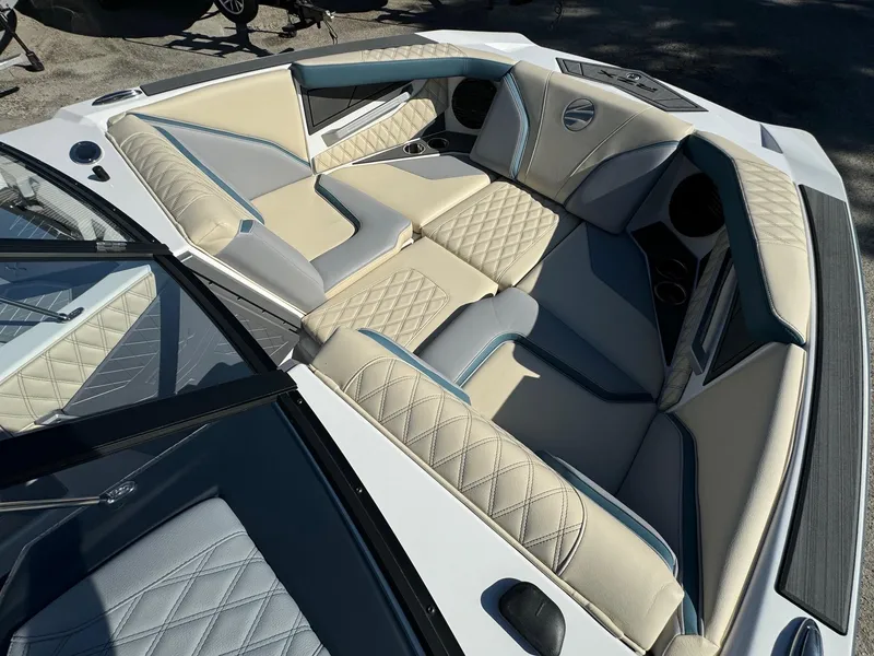 Slide: The Image of 2025 Tigé 22RZX boat interior with luxurious beige and gray seating. - 13