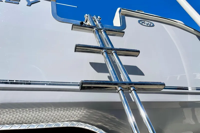 Slide: The Image of Stainless steel ladder on 2025 Key West 263 FS boat under clear blue sky. - 10