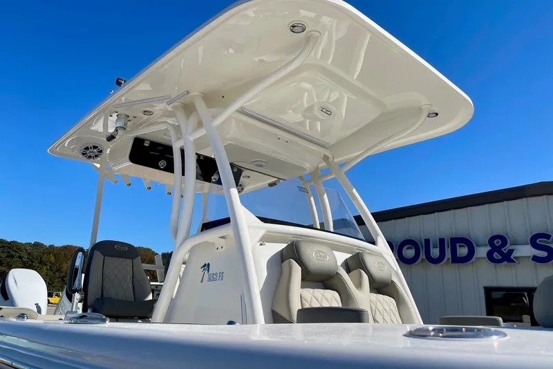 Slide: The Image of 2025 Key West 263 FS boat with T-top and seating, under clear blue sky. - 13