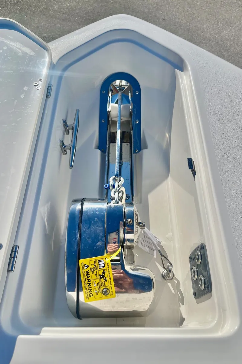 Slide: The Image of 2025 Key West 263 FS boat anchor compartment with stainless steel anchor. - 17