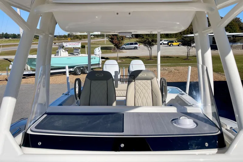 Slide: The Image of 2025 Key West 263 FS boat interior with modern seating and dashboard. - 27