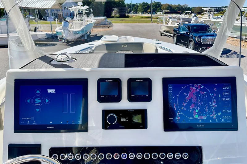 Slide: The Image of Key West 263 FS 2025 boat dashboard with advanced navigation screens and controls. - 30