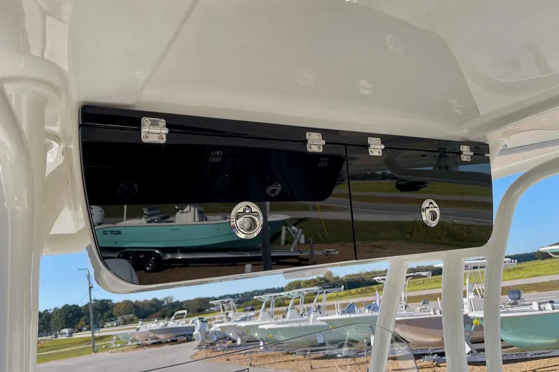 Slide: The Image of 2025 Key West 263 FS boat storage compartment with sleek black finish. - 38