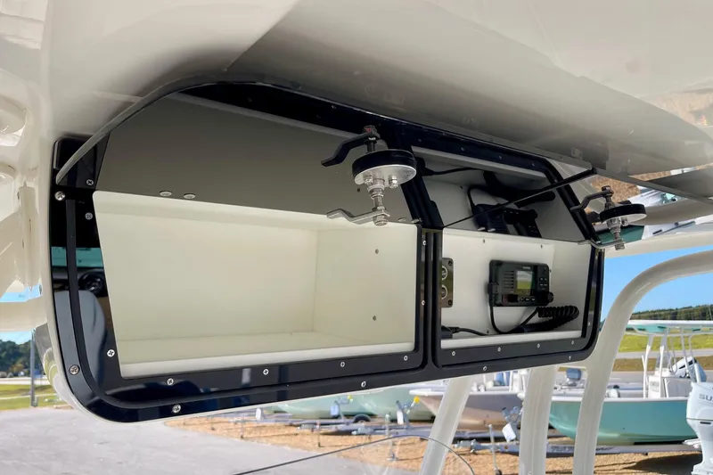 Slide: The Image of Key West 263 FS 2025 boat storage compartment with radio equipment. - 39