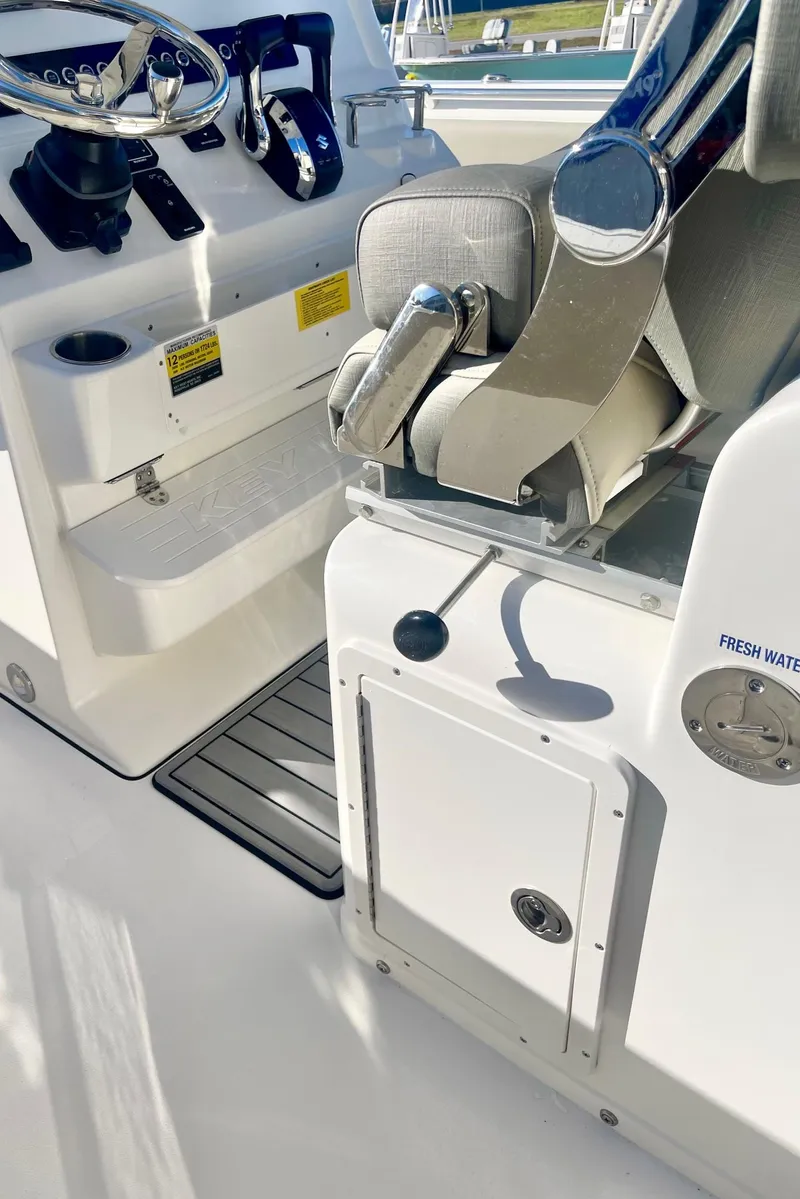 Slide: The Image of 2025 Key West 263 FS boat interior with steering wheel and seating. - 47