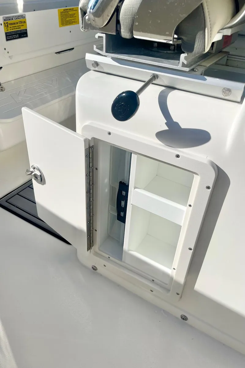 Slide: The Image of 2025 Key West 263 FS boat storage compartment with open door. - 48