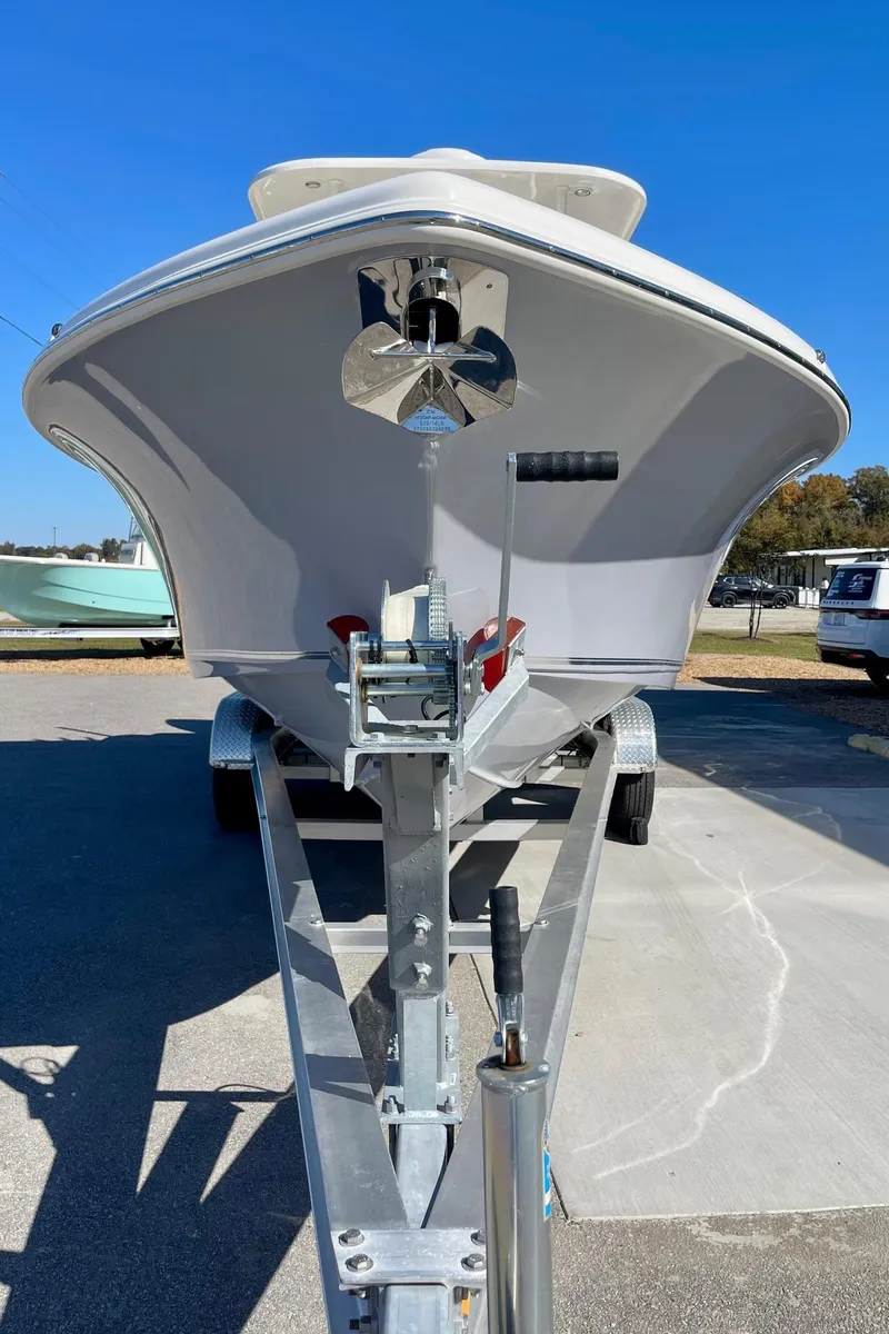 Slide: The Image of 2025 Key West 263 FS boat on trailer, front view, clear blue sky. - 5