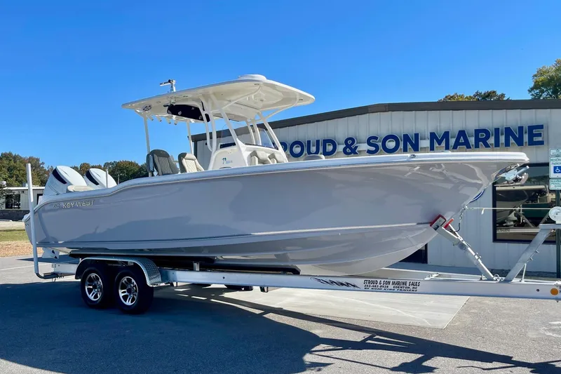 Slide: The Image of 2025 Key West 263 FS boat on trailer at marine dealership. - 7