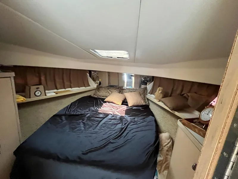Slide: The Image of 1994 Tiara Yachts 3600 Convertible Sportfish cabin with cozy bed and elegant decor. - 10
