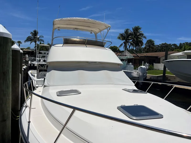 Slide: The Image of 1994 Tiara Yachts 3600 Convertible Sportfish docked under clear blue sky. - 16