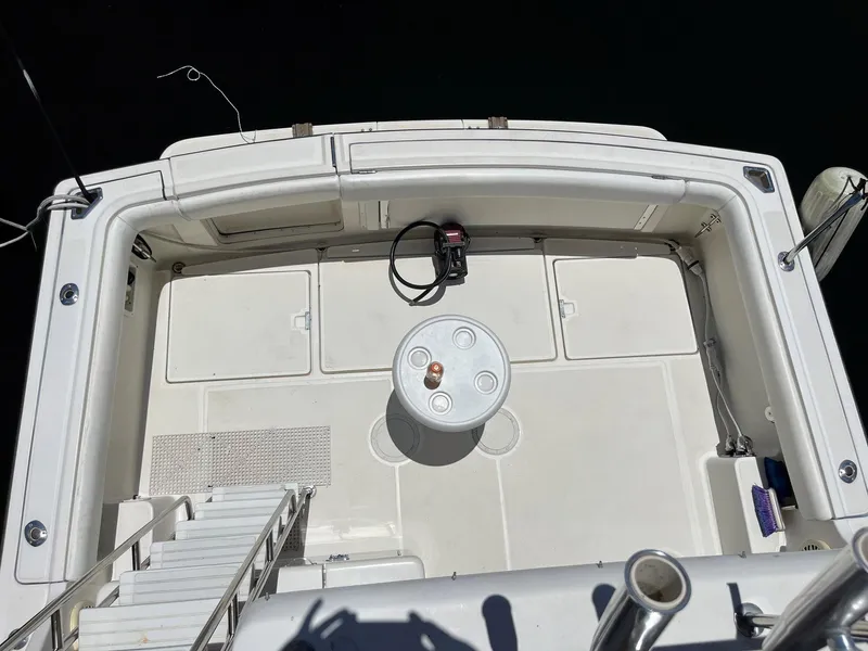 Slide: The Image of 1994 Tiara Yachts 3600 Convertible Sportfish deck, featuring spacious layout and fishing equipment. - 23