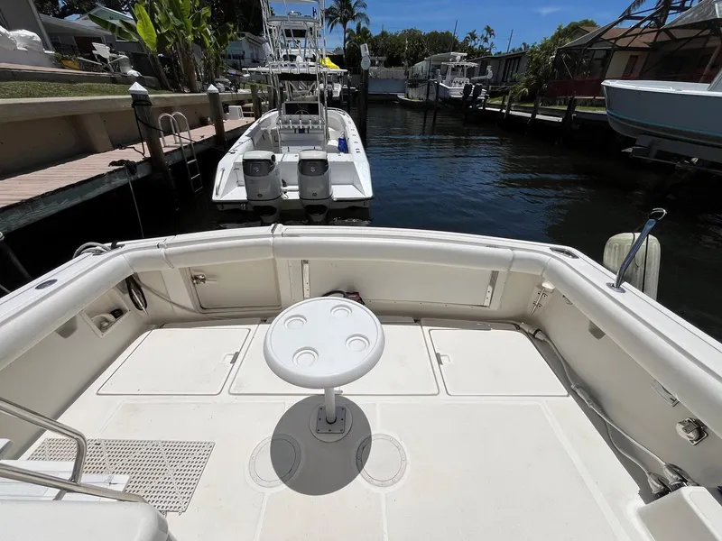 Slide: The Image of 1994 Tiara Yachts 3600 Convertible Sportfish boat deck with seating and table in marina. - 25