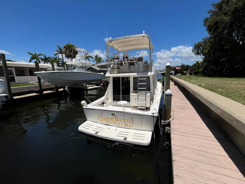Slide: The Image of 1994 Tiara Yachts 3600 Convertible Sportfish docked by a sunny waterfront. - 27