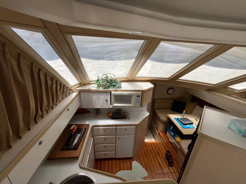 Slide: The Image of Interior of 1994 Tiara Yachts 3600 Convertible Sportfish with kitchen and seating area. - 6
