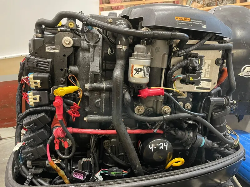 Slide: The Image of Close-up of a 2003 custom work boat engine with visible wiring and components. - 10