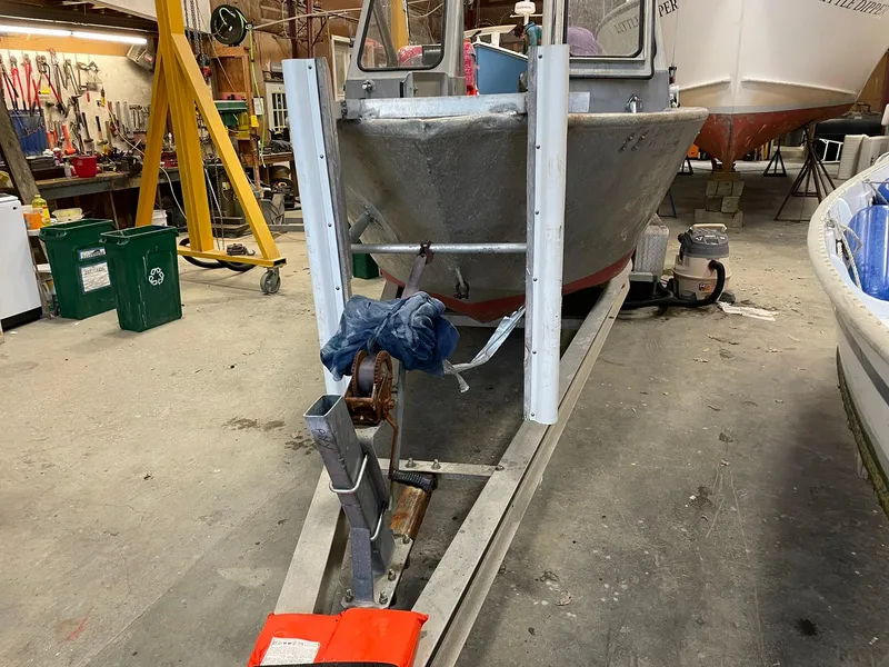 Slide: The Image of Custom 2003 work boat on trailer in workshop setting. - 12