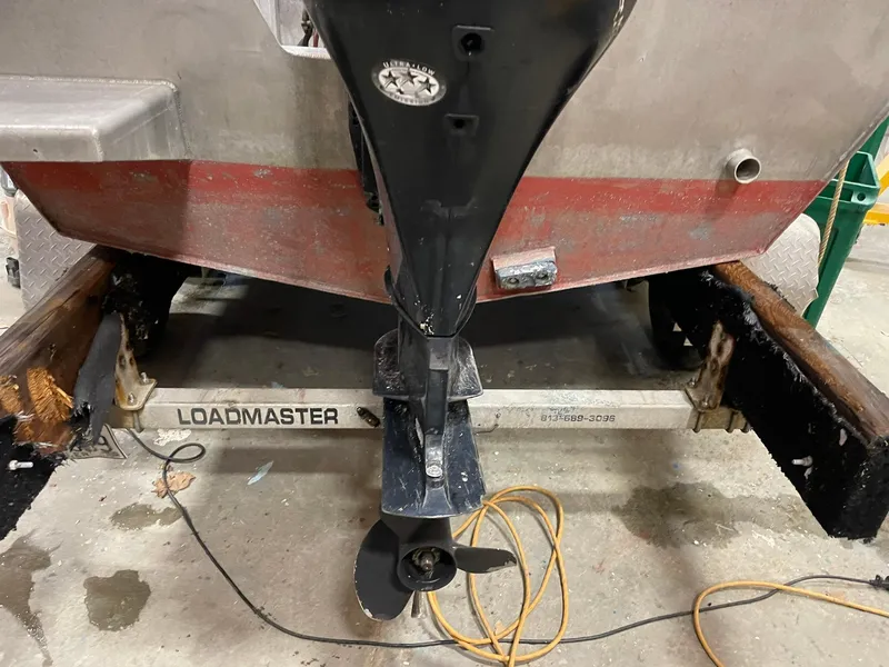 Slide: The Image of Custom 2003 work boat on Loadmaster trailer, showing propeller and hull details. - 13