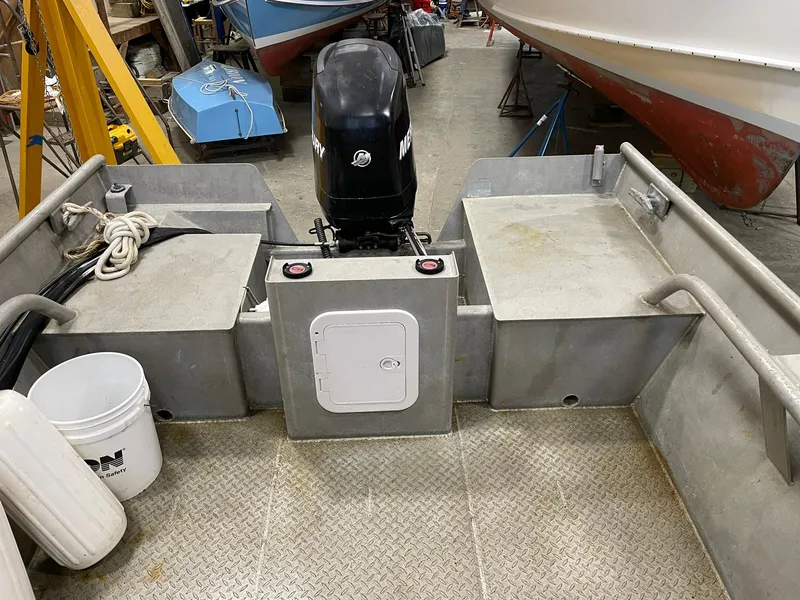 Slide: The Image of 2003 custom work boat with outboard motor in a workshop setting. - 15