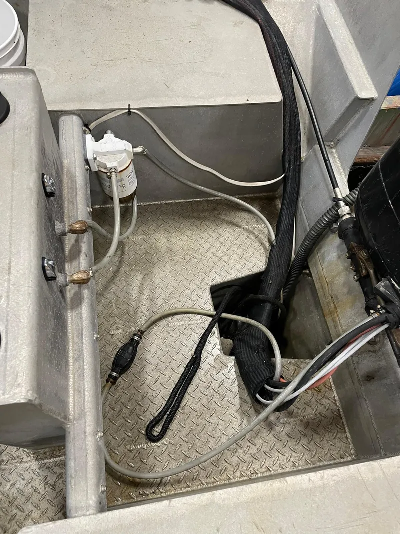 Slide: The Image of Custom 2003 work boat interior with cables and equipment on metal flooring. - 18