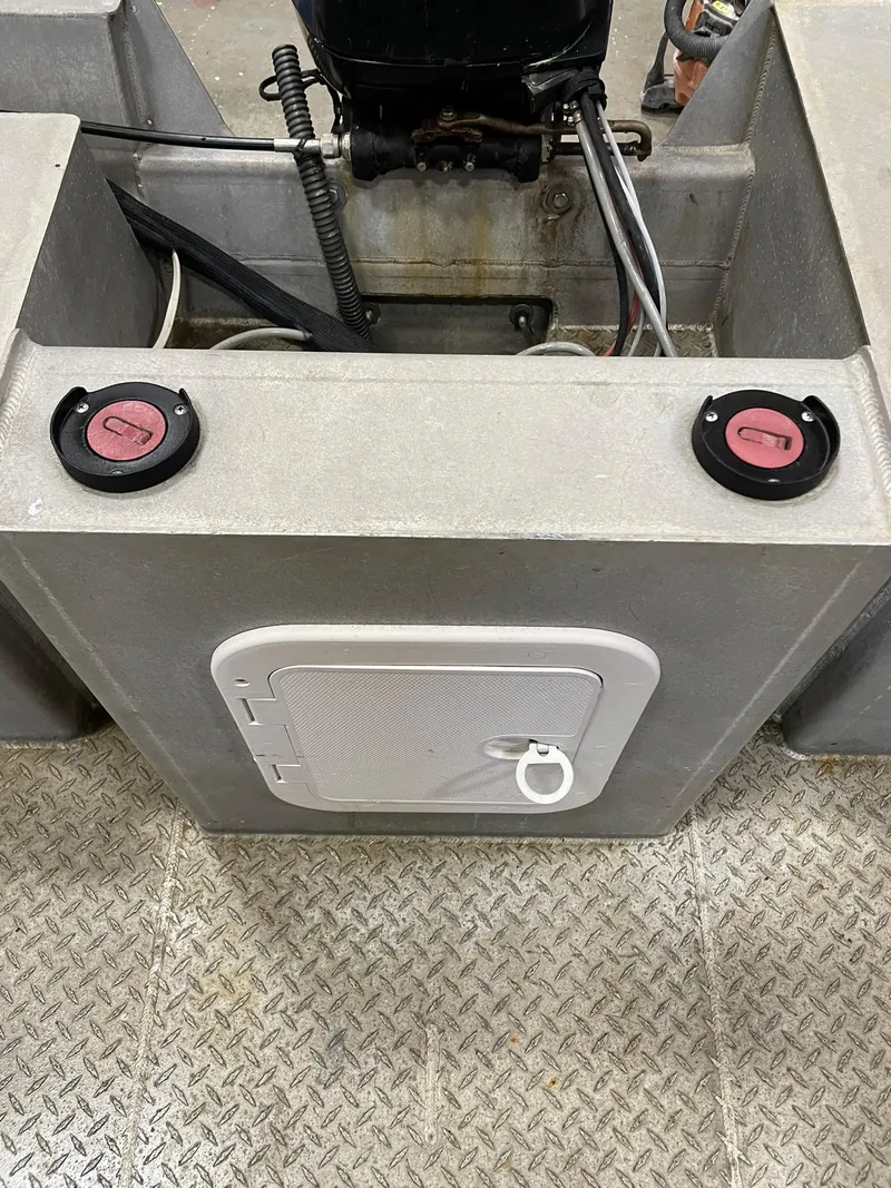 Slide: The Image of Custom 2003 work boat with dual fuel caps and storage compartment on metal flooring. - 21