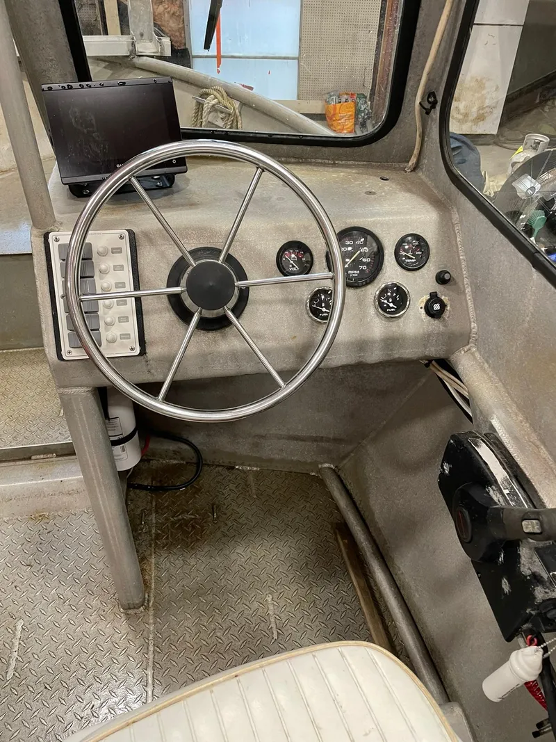 Slide: The Image of Interior of a 2003 custom work boat showing steering wheel and control panel. - 22
