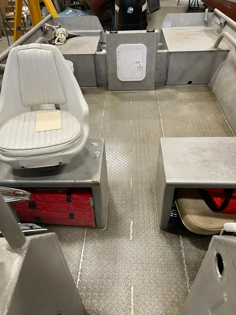 Slide: The Image of Interior of a 2003 custom work boat with metal flooring and seating. - 26