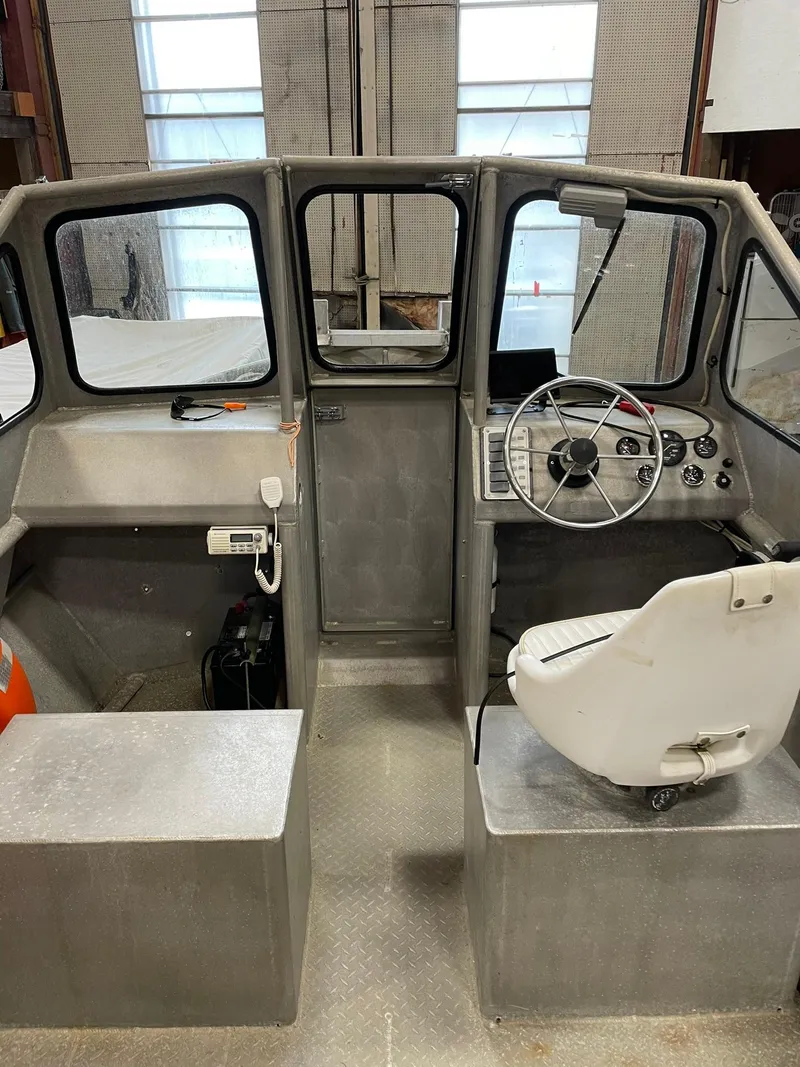 Slide: The Image of 2003 Custom work boat interior with steering wheel and control panel in a workshop setting. - 5