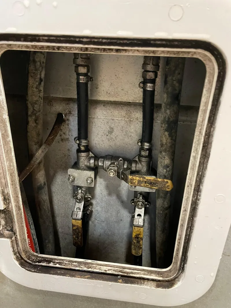 Slide: The Image of Pipes and valves inside a compartment of a 2003 custom work boat. - 7