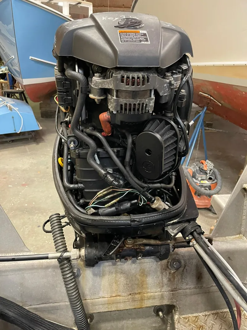 Slide: The Image of 2003 Custom work boat engine in workshop setting, showcasing detailed mechanical components. - 8