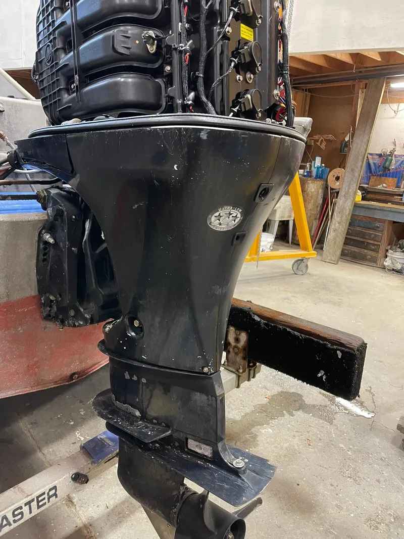 Slide: The Image of Outboard motor on a 2003 custom work boat in a workshop setting. - 9