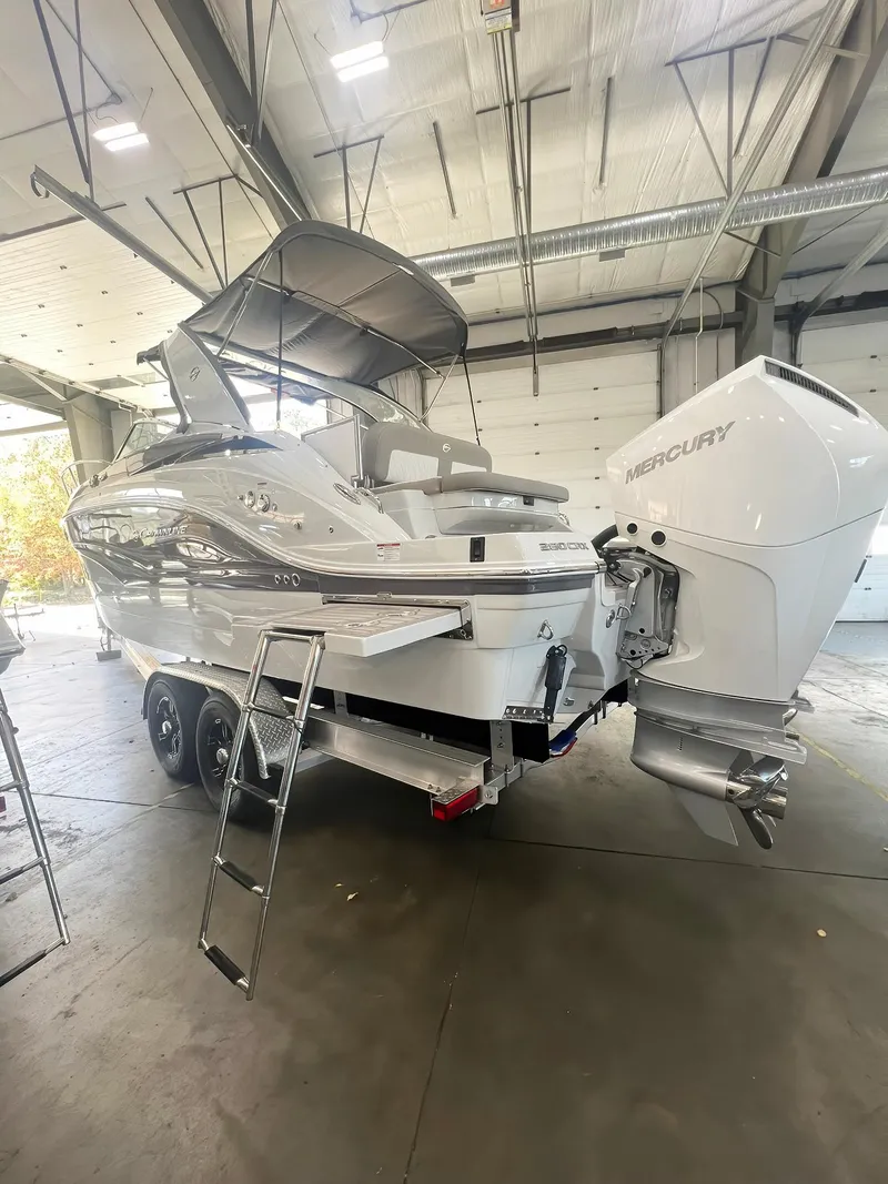 Slide: The Image of 2025 Crownline 280 CRX boat with Mercury engine in a spacious indoor setting. - 1