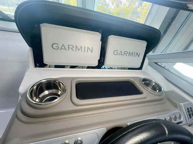 Slide: The Image of Dashboard of 2025 Crownline 280 CRX with dual Garmin displays and cup holders. - 10