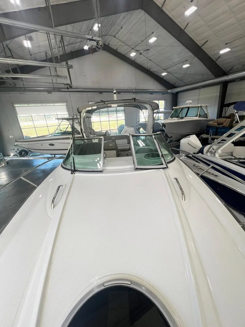 Slide: The Image of 2025 Crownline 280 CRX boat in showroom, sleek design, modern interior. - 12