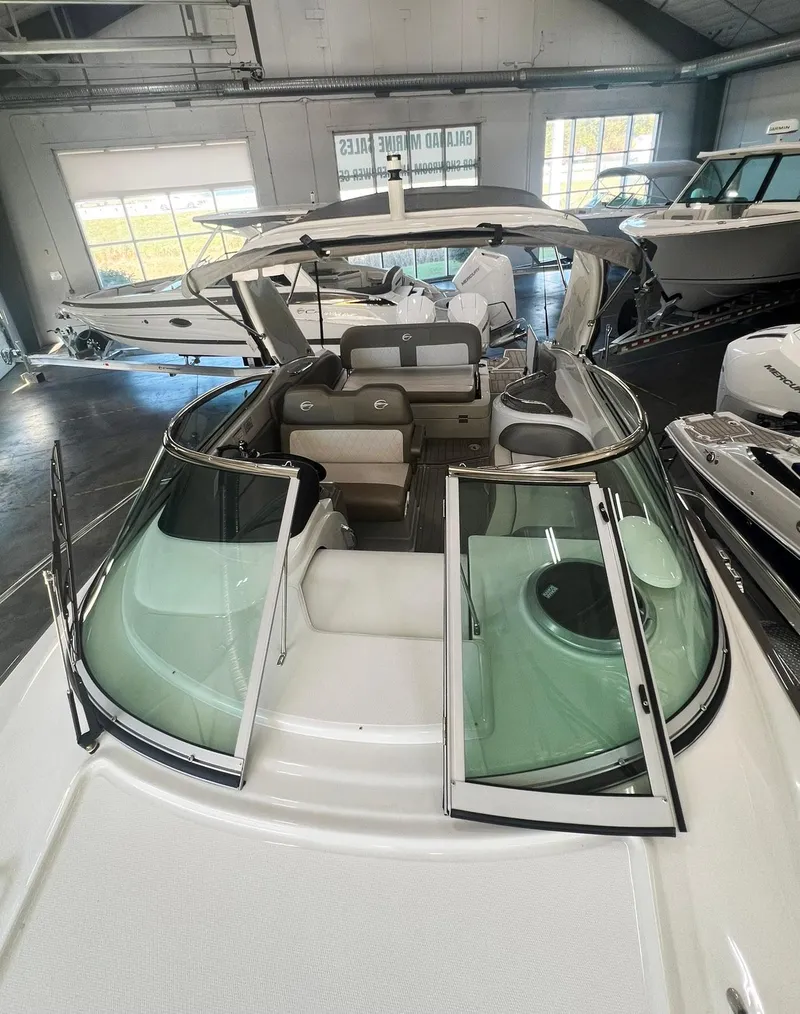 Slide: The Image of 2025 Crownline 280 CRX boat interior with open windshield in showroom. - 13