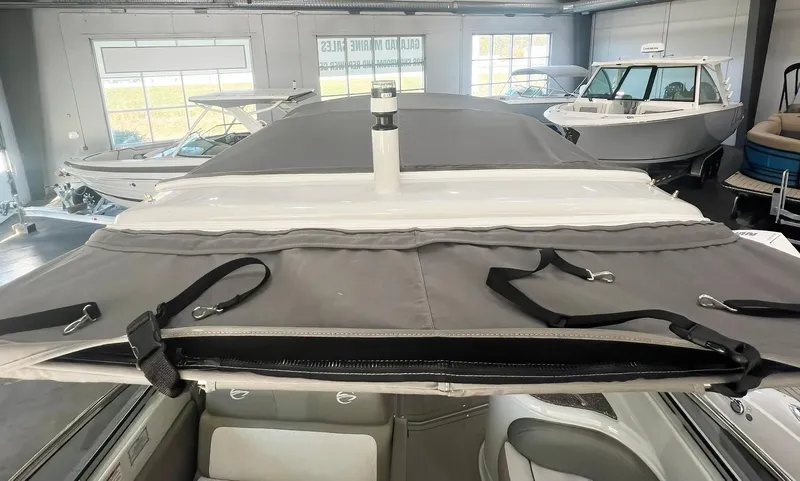 Slide: The Image of 2025 Crownline 280 CRX boat interior with protective cover in showroom. - 15