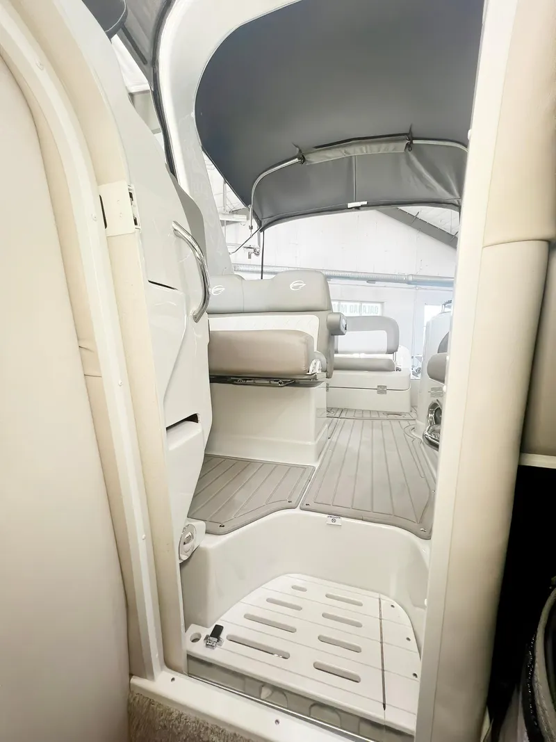 Slide: The Image of 2025 Crownline 280 CRX boat interior with seating and canopy. - 16