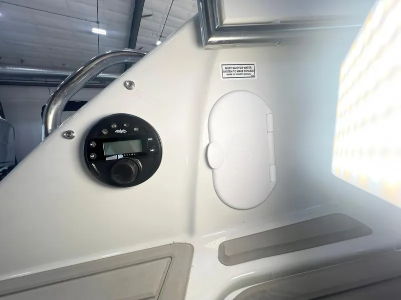Slide: The Image of 2025 Crownline 280 CRX boat interior with control panel and storage compartment. - 18