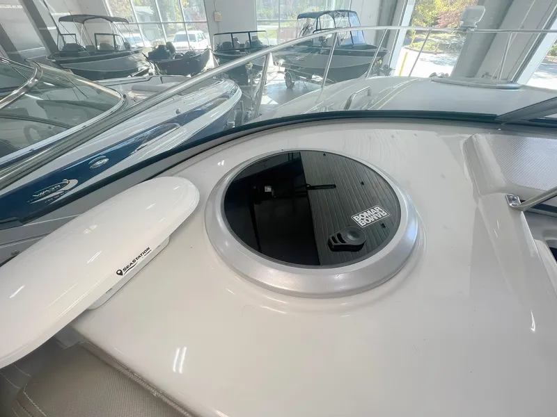 Slide: The Image of 2025 Crownline 280 CRX boat deck with hatch in showroom setting. - 23