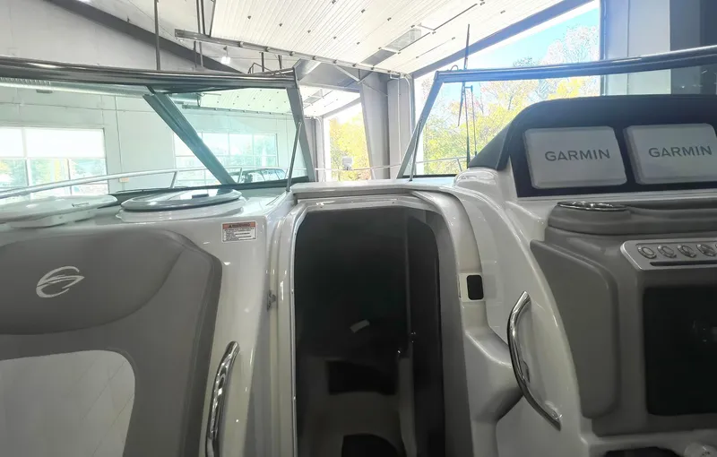 Slide: The Image of 2025 Crownline 280 CRX boat interior with Garmin navigation displays. - 25