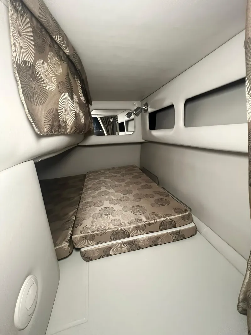 Slide: The Image of Interior cabin of 2025 Crownline 280 CRX boat with patterned cushions. - 26