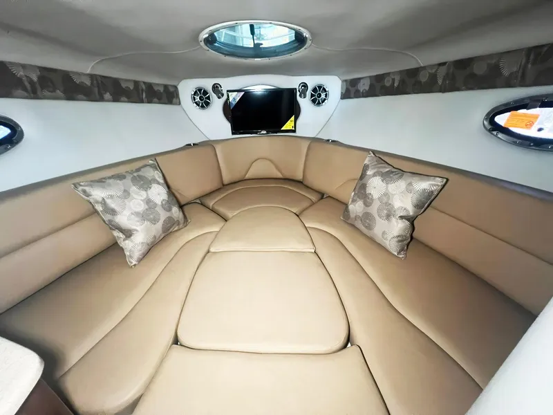 Slide: The Image of Luxurious interior of 2025 Crownline 280 CRX boat with beige seating and decorative pillows. - 31