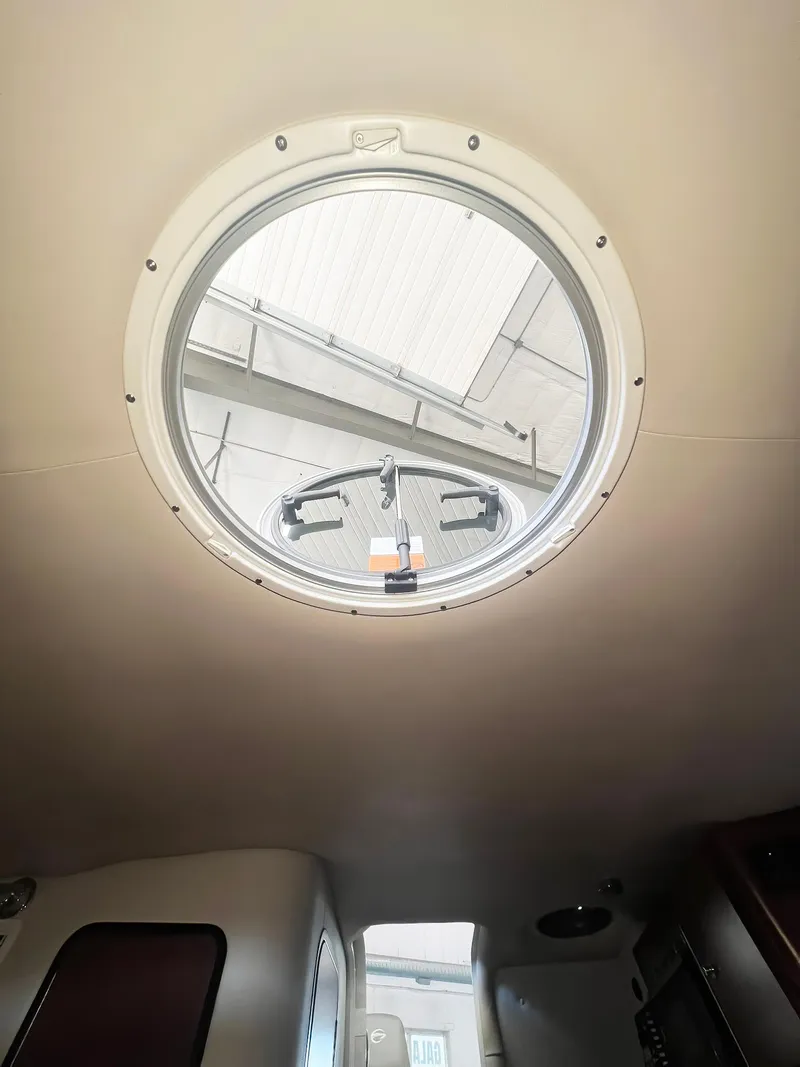 Slide: The Image of 2025 Crownline 280 CRX cabin interior with circular window view. - 35