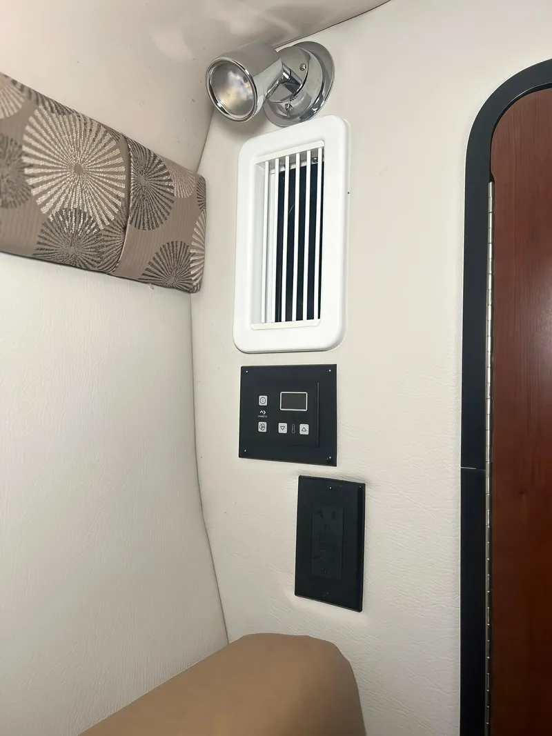 Slide: The Image of Interior of 2025 Crownline 280 CRX boat with vent, control panel, and light fixture. - 36