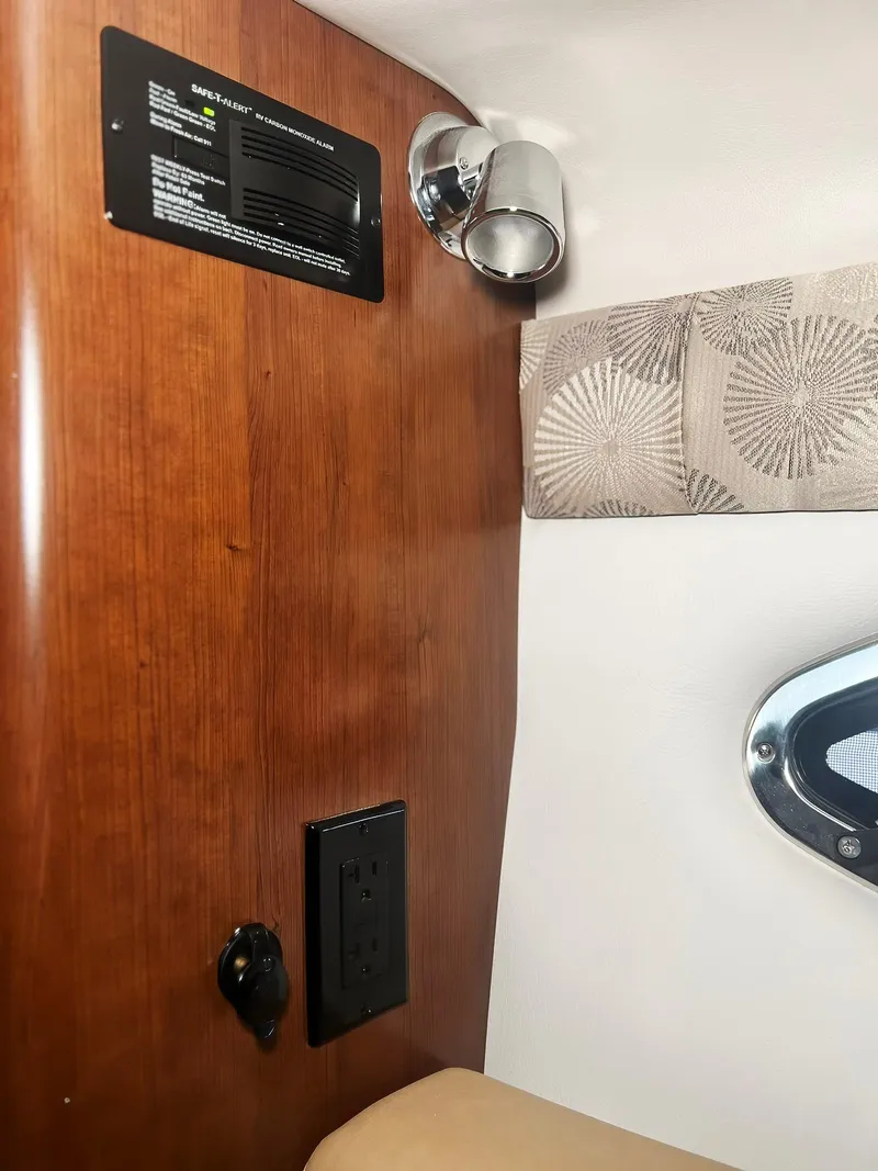 Slide: The Image of Interior of 2025 Crownline 280 CRX boat with wood paneling and modern lighting. - 37