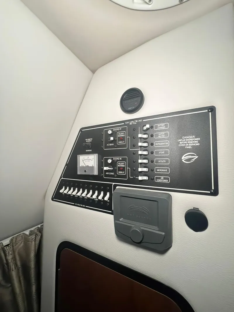 Slide: The Image of Control panel inside 2025 Crownline 280 CRX boat cabin, featuring switches and gauges. - 43