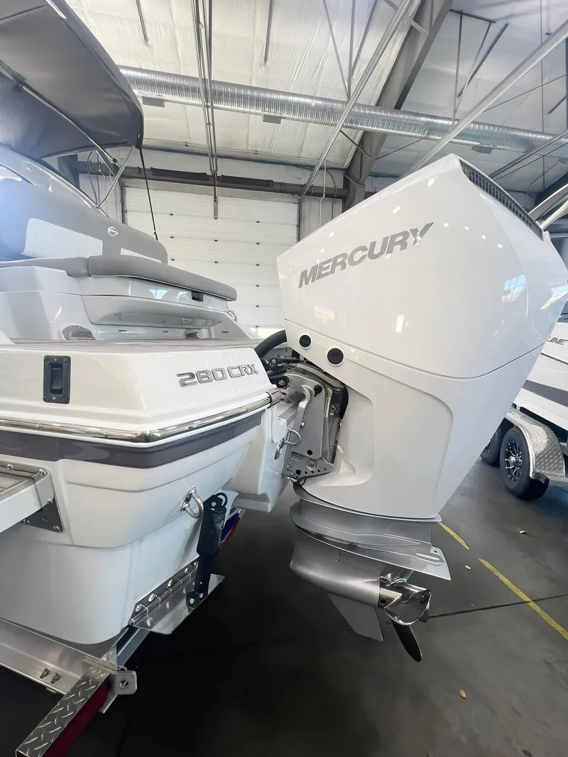 Slide: The Image of 2025 Crownline 280 CRX boat with Mercury outboard motor in a garage. - 44