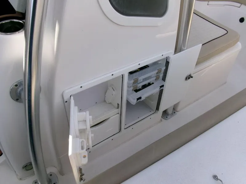 Slide: The Image of 2018 Sea Fox 266 Commander storage compartments with open doors on a boat deck. - 19