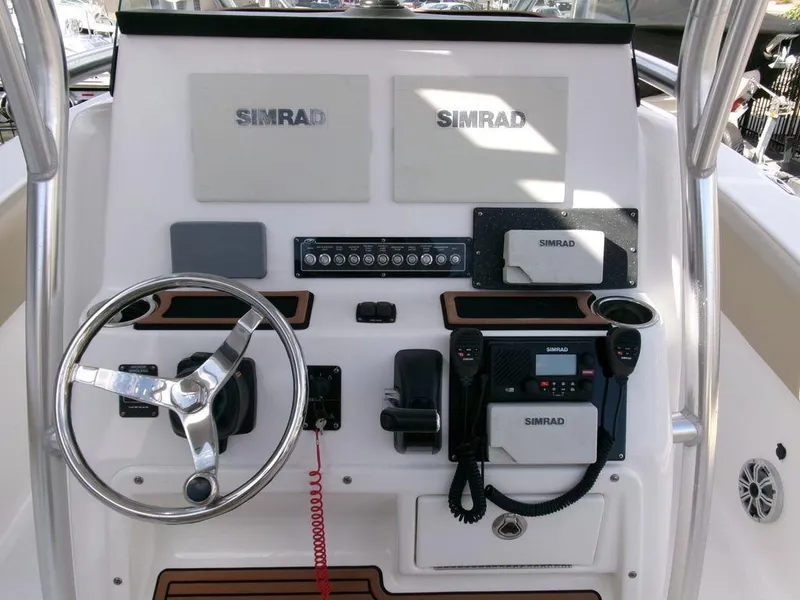 Slide: The Image of 2018 Sea Fox 266 Commander boat dashboard with Simrad electronics and steering wheel. - 21